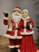 PAPAI NOEL COM MAMÃE NOEL COM LISTA EM RESINA 23,5CM