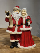 PAPAI NOEL COM MAMÃE NOEL COM LISTA EM RESINA 23,5CM