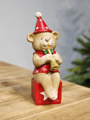 URSO EM RESINA MUSICO COM CORNETA 20CM